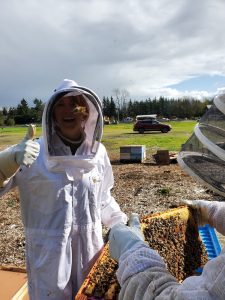 beekeeper at GRuB holding a honeycomb