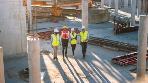 four construction workers on a job site