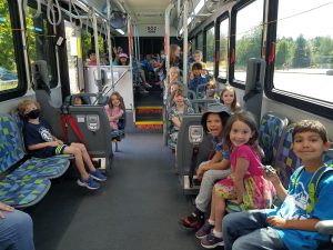 a group of kids with bike helmets on an Intercity Transit bus