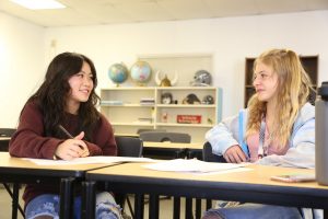 two high schoolers at desks