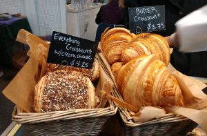croissants and other breads in baskets at The Bread Peddler at Olympia Farmers Market