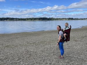 Dr. Tina Hajewski with one of her children on her back at the beach