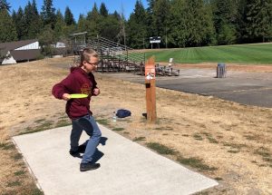 Nixon Anderson at the first tee at The Evergreen State College disc golf course in Olympia