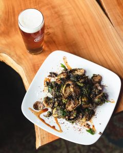 plate of deep fried Brussel sprouts and a beer at Well 80 brewery in Olympia