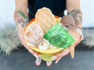 September's themed bucket drink at Northwest Grind Caramel Apple, held by a woman