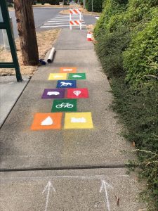 Painted square activity designs on a sidewalk