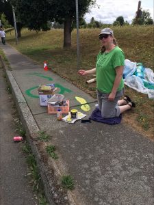 person painting the Child Care Action Council Sense of Place Walk