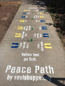 Peace Peath painted on sidewalk 