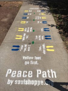 Peace Peath painted on sidewalk