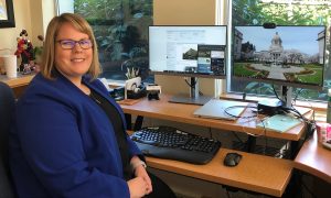 State Archivist Heather Hirotaka sitting at her desk