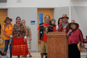 Nisqually Tribe members at the Southworth Elementary ribbon cutting standing at the stage