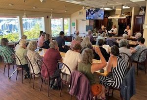 large group of people sitting at a long table at Bayview School of Cooking in Olympia