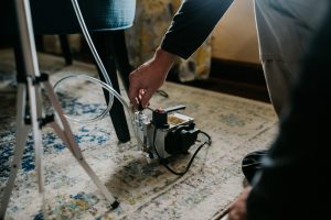 a Boggs home inspector using testing equipment on a rug