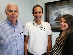 two men and a woman standing together