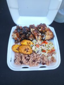 rices, vegetables and chicken in a styrofoam to go container from Jerk An Tingz in Lacey