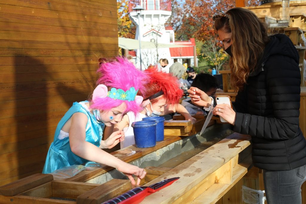 Kids in Halloween costumes sluicing for treasure at Boo Bash in Olympia