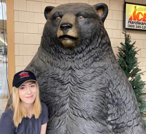 Emma Porter standing by a giant bear statue