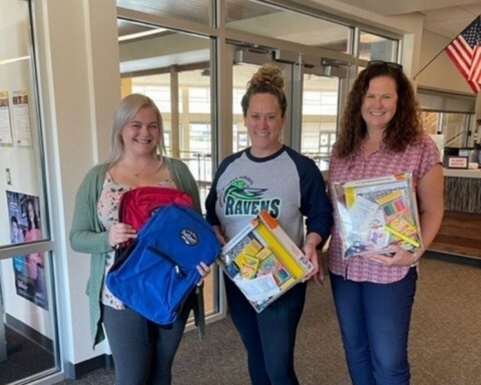 Melanie Bakala (right) and her team deliver collected school supplies to the Salish Middle School in Lacey.