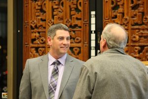 two men wearing suits talking