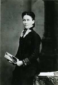 Mary O’Neil, Olympia school leather, with a book in her hand