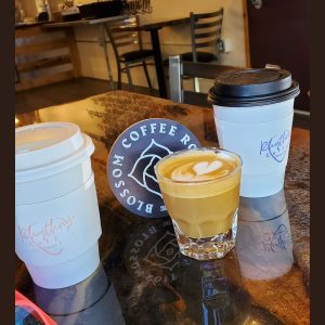 two hot to go coffees and one iced on a table at Rhythms Coffee in Olympia