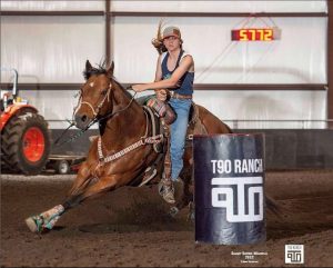 girl barrel racing on her horse at T90 Ranch