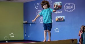 child on a balance beam at The Little Gym Olympia