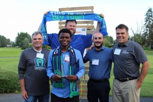Issa Hassan, who was awarded the 2018 Men's Sports Star of the Year, poses with members and leadership of the Oly Town Artesians FC. 