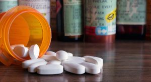 a prescription pill bottle spilled out on a counter