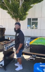 Tevin Campbell  standing at a grill