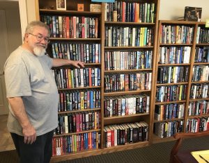 Owner Murlin Varner shows the books in the lobby of Turtleman Used Books.