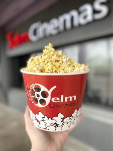 Yelm cinema popcorn in a tub in someone's hand