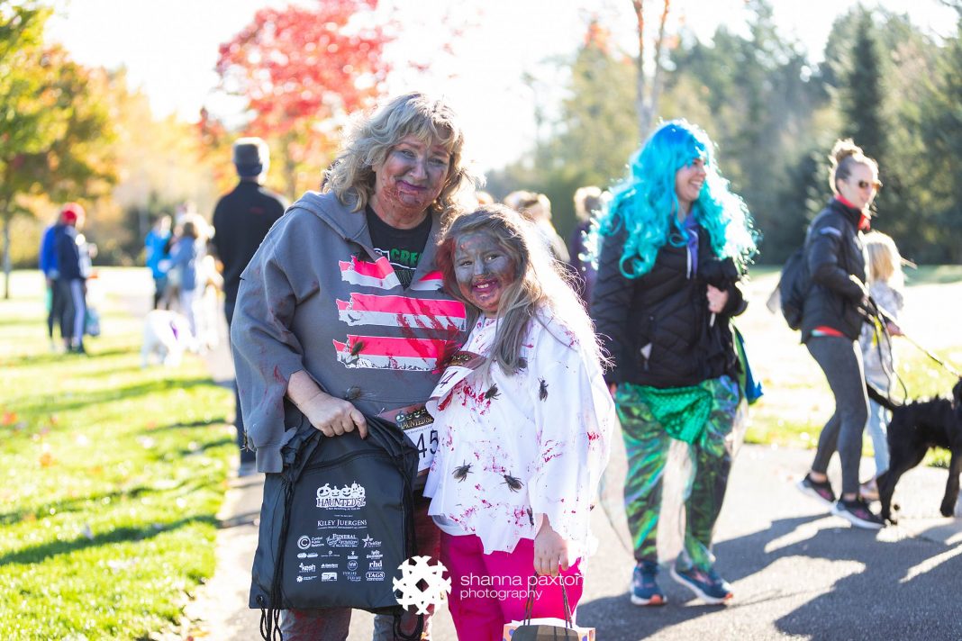 mother-daughter duo at the 2021 Haunted 5k in zombie costumes
