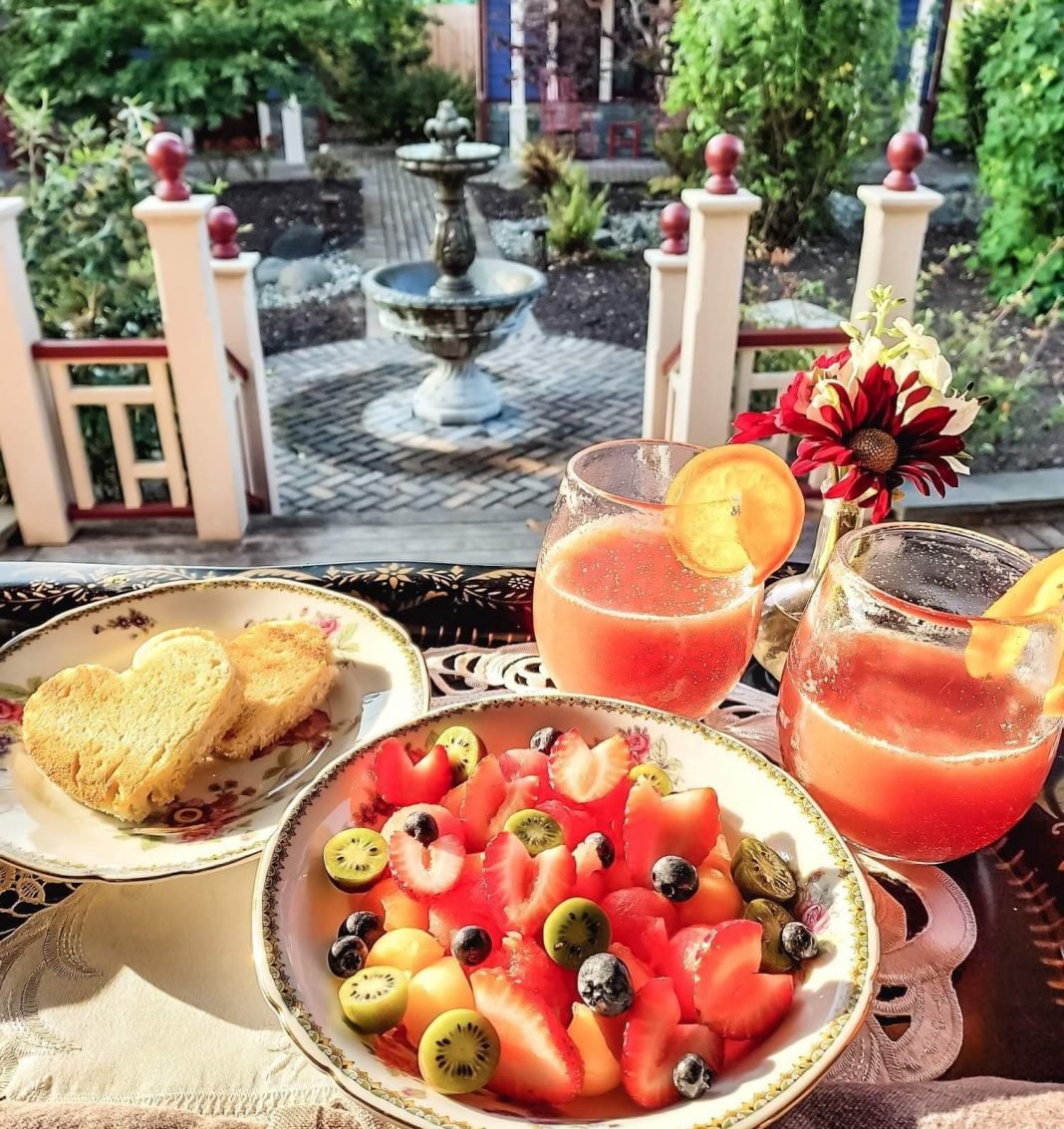 a breakfast for two with a view of a patio at The Marie Bed & Breakfast in Olympia
