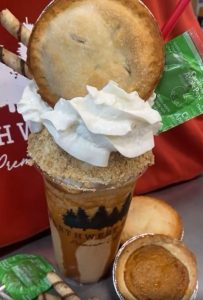 fancy blended coffee drink with whipped cream and a mini pie on top