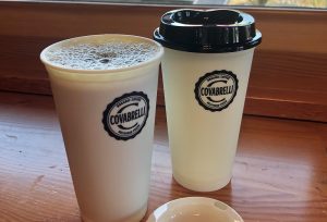 two to-go coffee cups with Covabrellie coffee from The Park Side Cafe