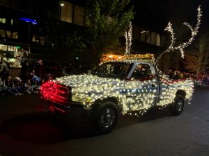 pick up truck covered in lights with a red nose at the City of Lacey Christmas Parade