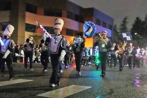 marching band in a nighttime Christmas parade in Lacey 