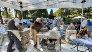 Tenino Stone Carvers under a tent at an outdoor event