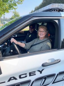 Civilian driving a Lacey police car 