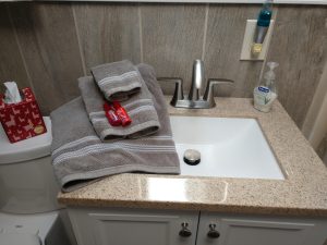 bathroom sink with two towels sitting on it