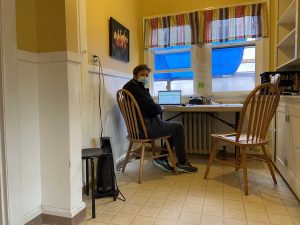 Nancy Davies, a SideWalk volunteer, working in the office at a desk