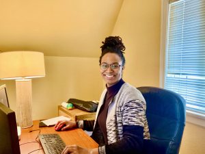 Olivia Hickerson sitting at a desk at the SideWalk office