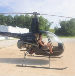Dr. Amy Winter piloting a helicopter 