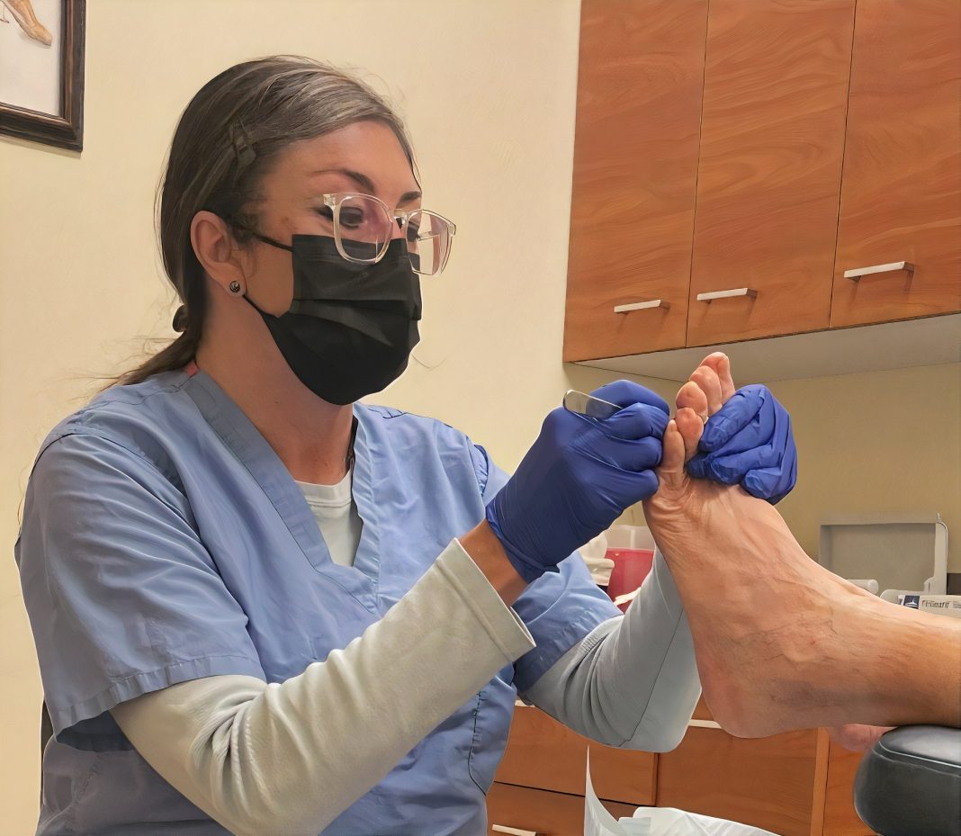 Dr. Amy Winter examining a patient's foot
