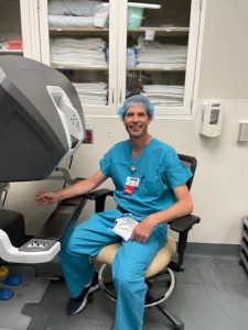 Dr Bell at Olympia OBGYN sitting by the robotic control center