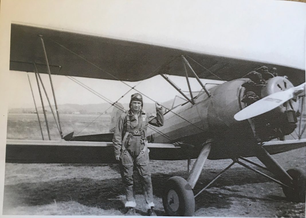 Neil Shannon with biplane,. black and white photo
