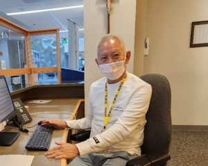 volunteer sitting at a desk at Providence St. Peter Hospital in Olympia