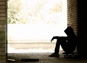 sillloutte of a person sitting in alley