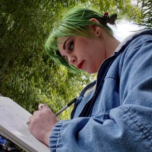 Trish Hall sketching in a notebook